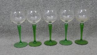 A set of five vintage hand blown green stem wine glasses. H.18 Diam.7 cm