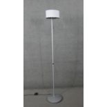 A contemporary standard lamp style reading light with adjustable directional bulb. H.177 Diam.30 cm