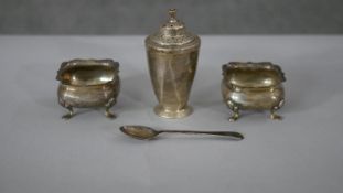A pair of silver cruets and a silver pepper shaker and spoon. Pepper shaker hallmarked:R&B for