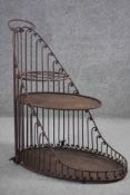 An early 20th century cast iron scrolling design three tiered plant pot stand. H.85 W.36 D.76 cm