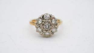 A 18 carat gold and white metal (tested platinum) diamond cluster ring. Set with seven round
