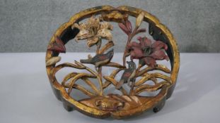 A painted carved giltwood and polychrome pierced design stand with lily and song bird decoration.