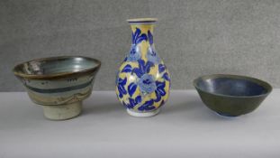 A collection of ceramics. Including an Oriental blue and yellow floral design vase and two pieces of