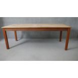 A Retrouvius refectory dining table with reclaimed poplar planked top raised on square tapering