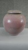 A large pink crackle glaze globular art pottery lidded storage jar. H.30 Diam.26cm