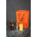 Three Hermes Caleche (empty) cosmetic bottles with original orange Hermes bag.