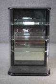 A C.1900 counter top display cabinet with bowed glass in ebonised frame. H.92 W.57 D.29 cm