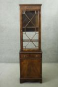 A Georgian style mahogany and satinwood strung narrow library bookcase. H.188 W.53 D.33 cm.