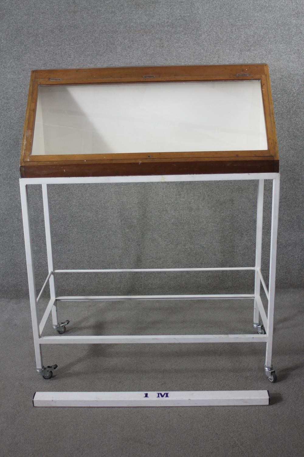 A lidded glazed mahogany display case on metal framed stand fitted with locking castors, from the - Image 5 of 5