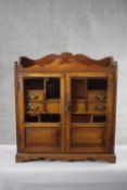 A 19th century oak table cabinet with glazed doors enclosing fitted interior on shaped bracket feet.
