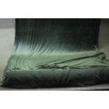 A roll of elasticated green velour fabric. W.180 cm