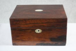 A Victorian rosewood dressing box. With red velvet lining and mother of pearl cartouche. Contains