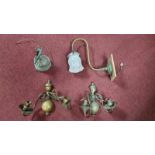 Four vintage wall mounted light fittings. A pair of two branch brass wall lights with scrolling