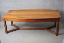 A contemporary American cherrywood refectory style dining table of bowed outline on square cross