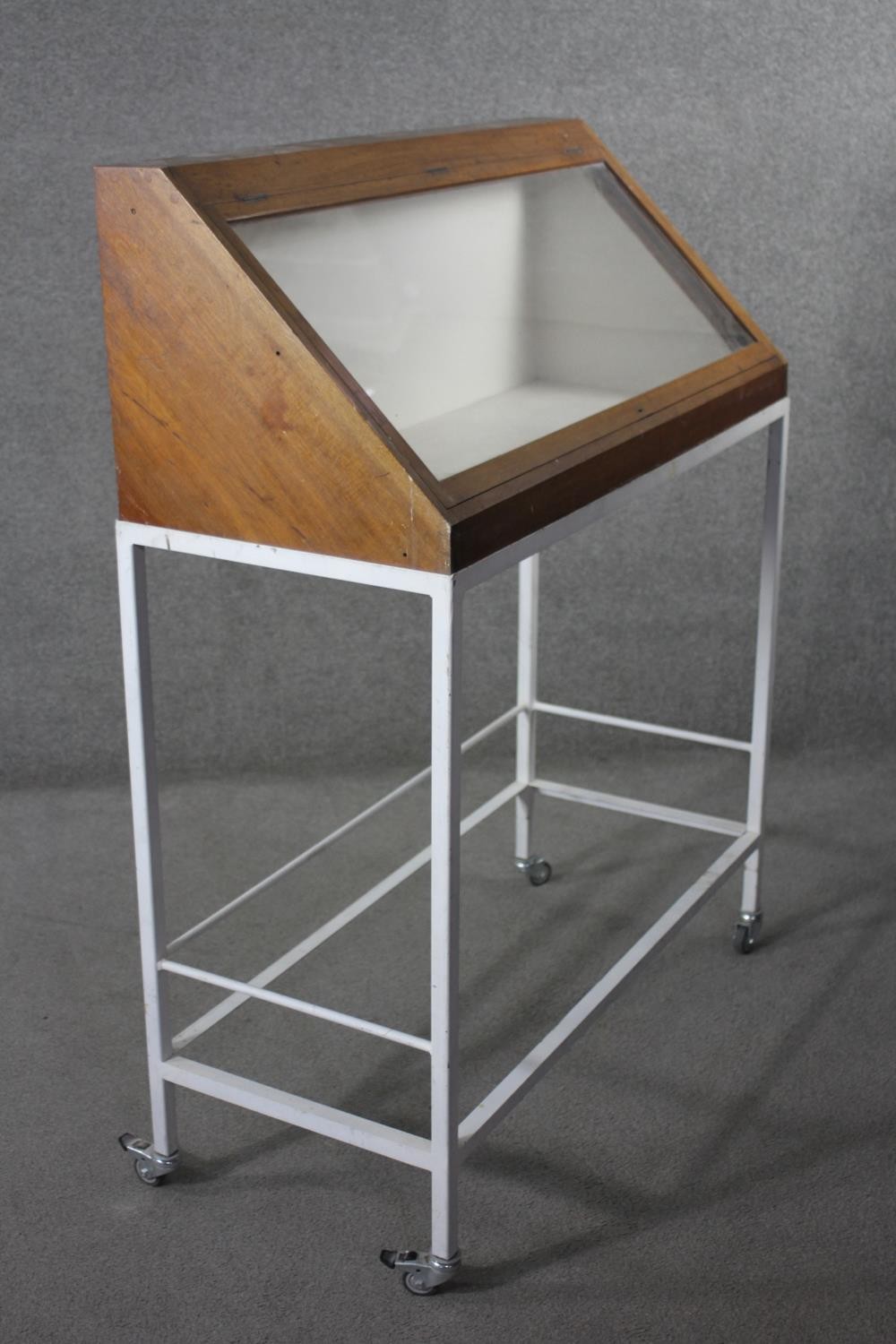 A lidded glazed mahogany display case on metal framed stand fitted with locking castors, from the - Image 2 of 5