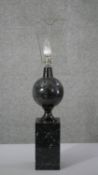 A carved black fossilised marble table lamp of architectural design. H.65 W.10 D.10 cm