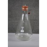 A large Pyrex scientific conical flask with bung. H.43 Diam. 22 cm.