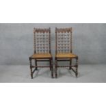 A pair of early 20th century walnut Carolean style hall chairs with pierced and carved back splats