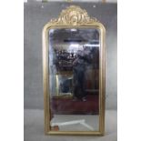 A full height gilt framed pier mirror with arched plate in moulded and beaded frame with shell