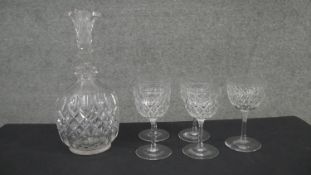 A cut crystal decanter with diamond pattern and a set of five cut crystal wine glasses. H.24 W.
