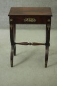 An Empire style mahogany lamp table fitted with frieze drawer and ormolu mounts on X frame supports.