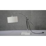 A contemporary adjustable chrome branched table light with white circular shade. H.49 W.58 D.14 cm