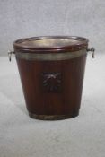 A George III mahogany and metal bound twin handled wine cooler of small size with shell carved