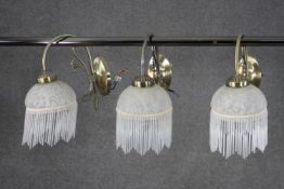 Three Art Deco style marble glass and brass wall mounted lights with beaded tasseled fringing. H.