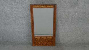A pier mirror with bevelled plate in Arts and Crafts style floral inlaid frame. H.66 W.35 cm