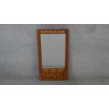 A pier mirror with bevelled plate in Arts and Crafts style floral inlaid frame. H.66 W.35 cm