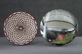 A vintage hand painted circular mirror with a lady in a garden along with a Islamic pattern