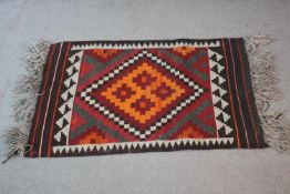 An Afghan Kelim rug with geometric design. L.108 W.68cm.