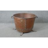 A Victorian studded copper twin handled log bucket on tripod legs. H.35 W.57cm