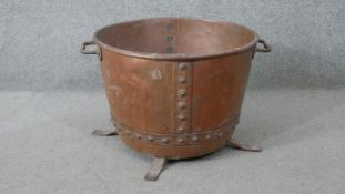 A Victorian studded copper twin handled log bucket on tripod legs. H.35 W.57cm