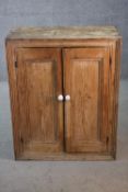 A Victorian rustic pine pantry cupboard with panel doors enclosing shelves. H.90 W.74 D.33 cm.