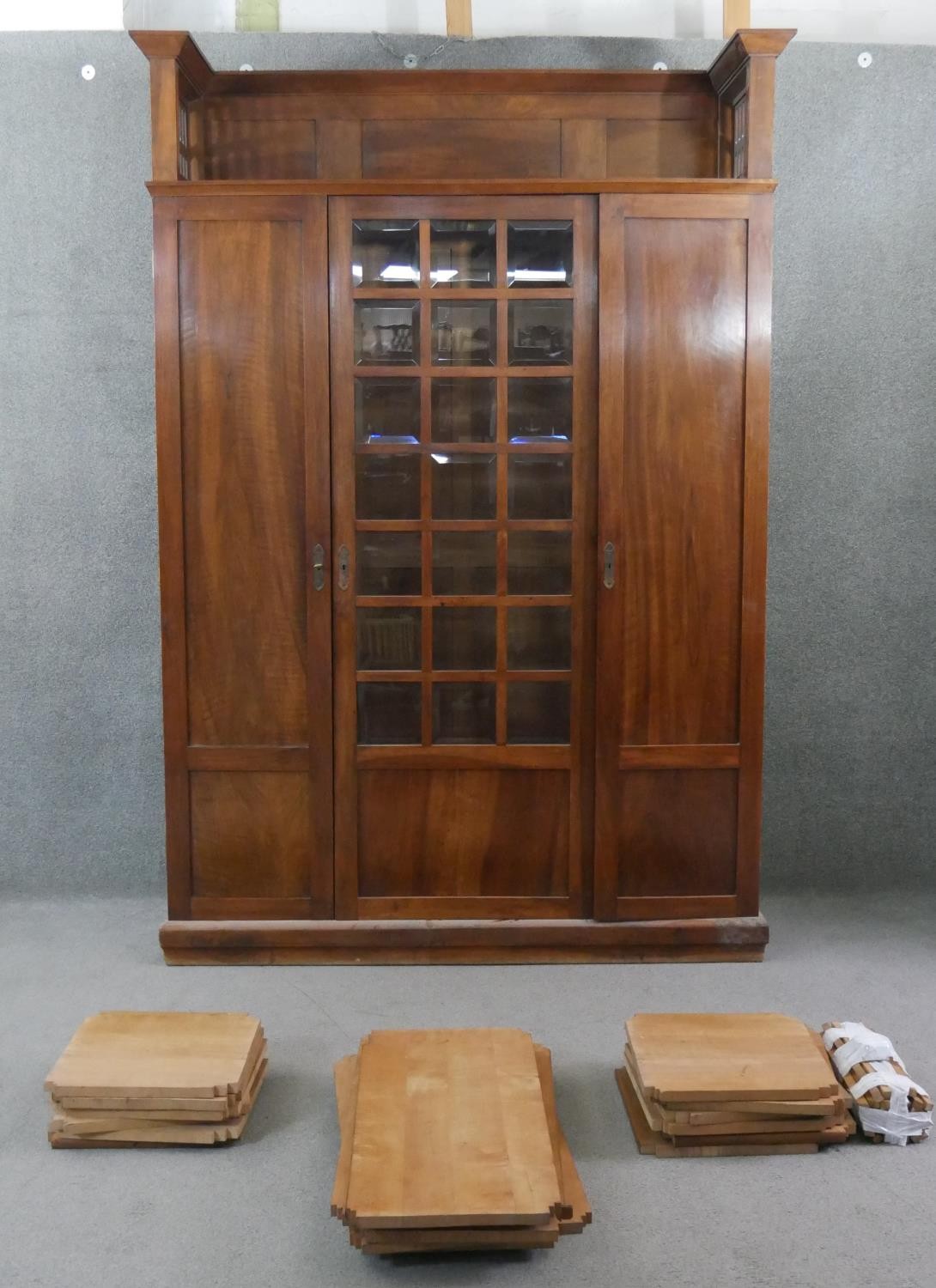A late 19th century walnut Arts and Crafts Glasgow School bookcase with pierced and panelled