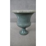 A large 19th century carved green marble pedestal urn with fluted rim. (some damage to base). H.53