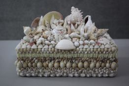 A vintage lined jewellery box encrusted with tropical seashells. H.7 W.29 D.22.cm.