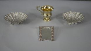 A collection of silver. Including a gilded French silver christening cup with engraved vine