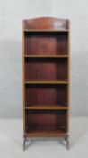 An Edwardian mahogany and satinwood strung narrow open bookcase on shaped supports. H.117 W.41 D.17