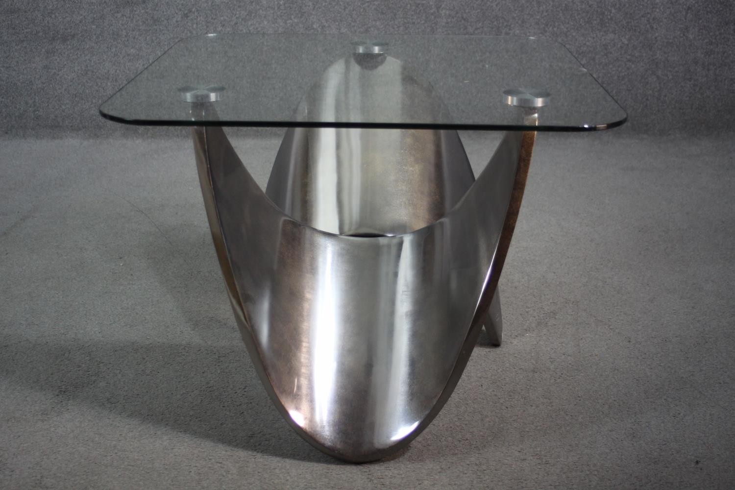 A contemporary occasional table with plate glass top on shaped brushed chromium base. H.55 W.71 D.72 - Image 5 of 7