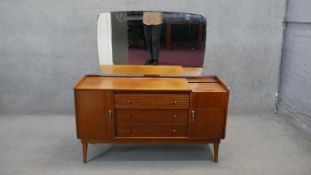 A vintage teak Austinsuite dressing table with tambour shutter revealing fitted well section