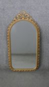 A vintage wall mirror with arched plate in foliate gilt frame. H.74 W.37CM