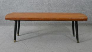 A 1960's vintage elm topped coffee table on splay supports. H.36 W.106 D.34CM