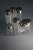 A collection of 19th century silver topped and faceted glass dressing table bottles and jars. H.