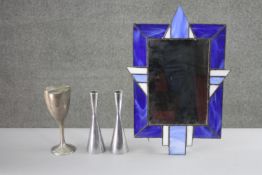A lead and blue stained glass picture frame along with a pair of hourglass candle holders and wine