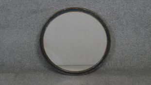 An early 20th century giltwood circular mirror with hanging chain. Diam.46 cm