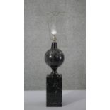 A carved black fossilised marble table lamp of architectural design. H.65 W.10 D.10 cm
