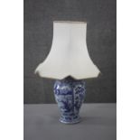 A Chinese blue and white Kangxi vase converted to a lamp. Hand painted with landscapes and floral