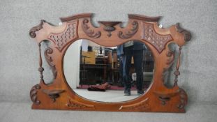 A late 19th century mahogany overmantel mirror in carved and moulded shaped frame. H.80 W.120 cm